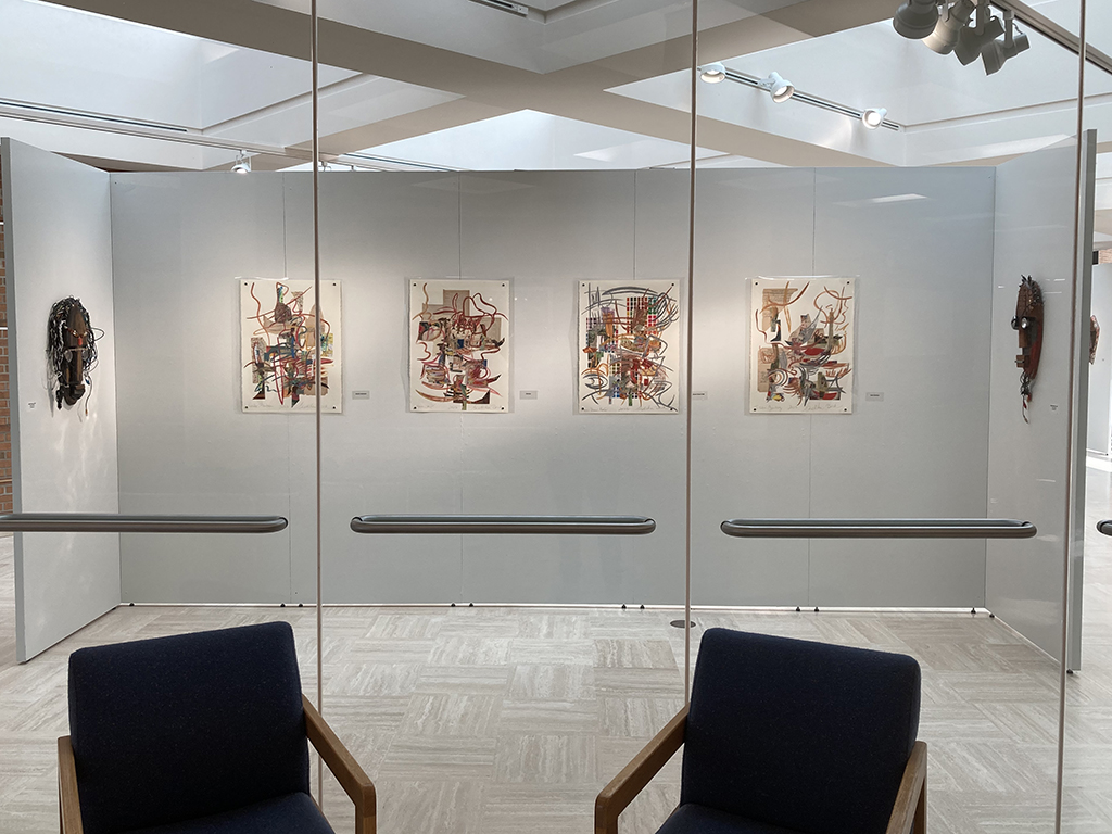 front wall from outside of gallery with 4 Beck paintings and 2 Allen masks on either side